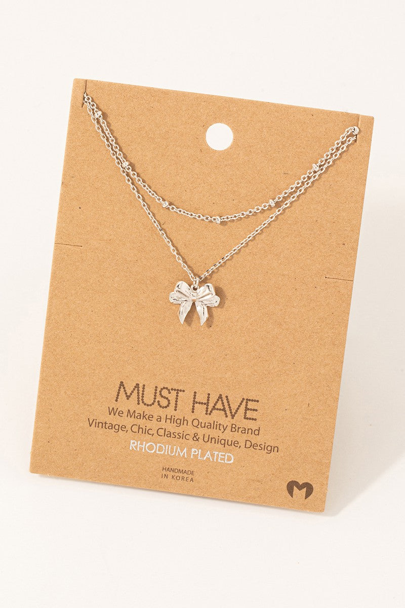 Knotted Ribbon Bow Pendant Necklace -  Rhodium Plated